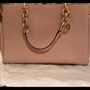Pink satchel with a crossbody attachment